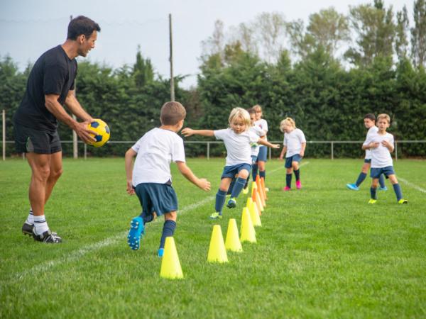 Children running around cones