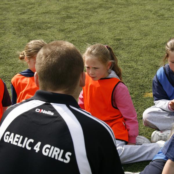 Gaelic4 Girls coach working with a group of children